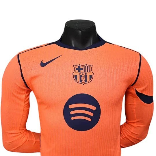 GOATkitz Barcelona 2025-26 adult player version third long sleeve jersey in orange with navy blue accents and logos.