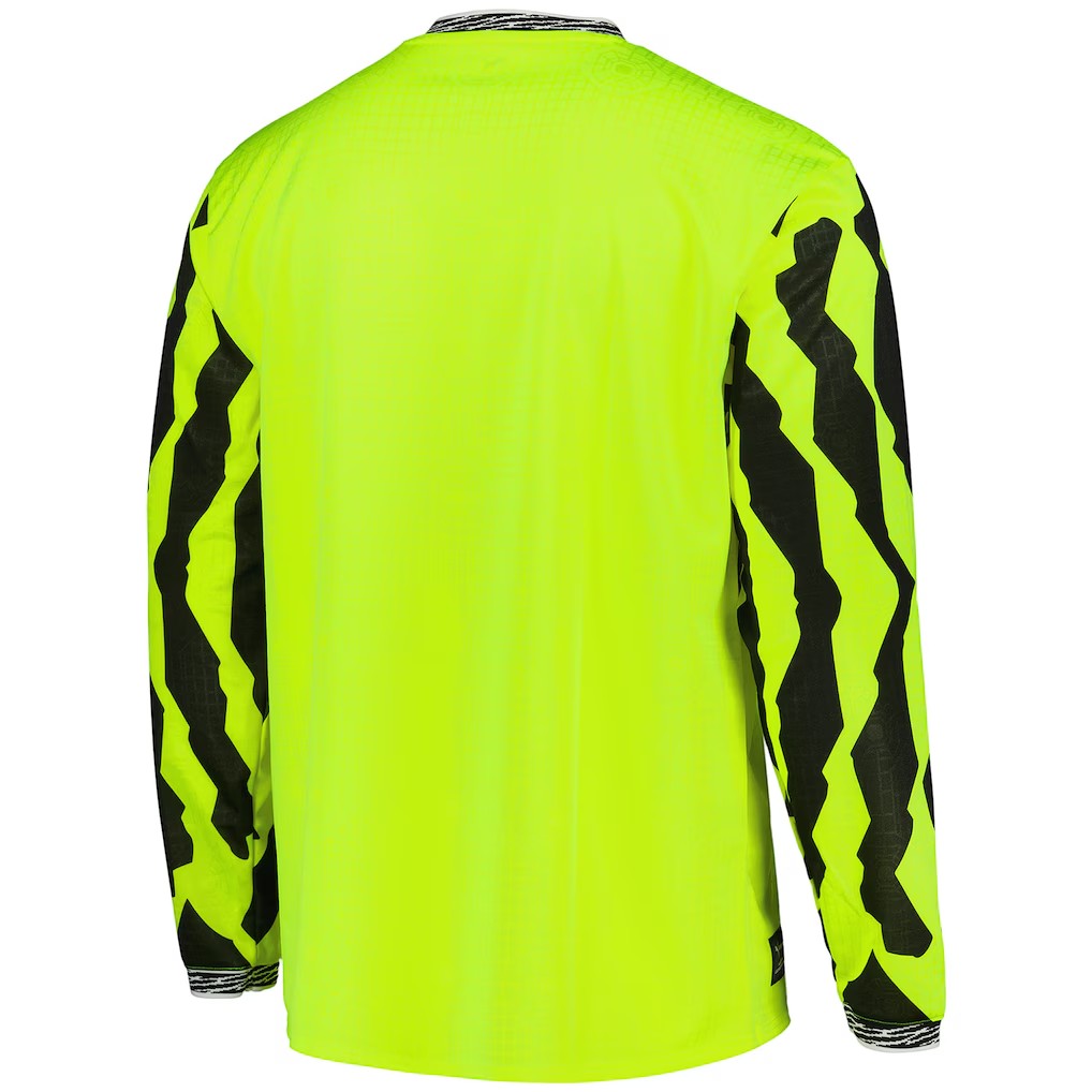 GOATkitz Borussia Dortmund 2025-26 neon yellow long sleeve jersey with black zigzag pattern on sleeves.
