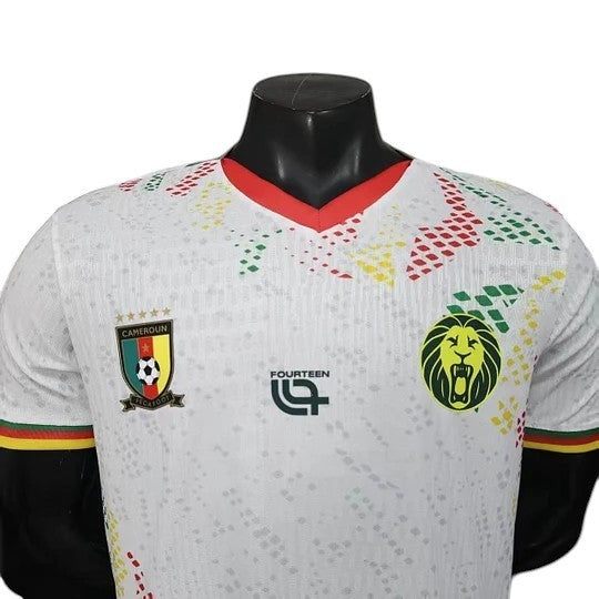 GOATkitz Cameroon 2026 player version away jersey in white with red, yellow, and green accents. Features team crest and lion logo.