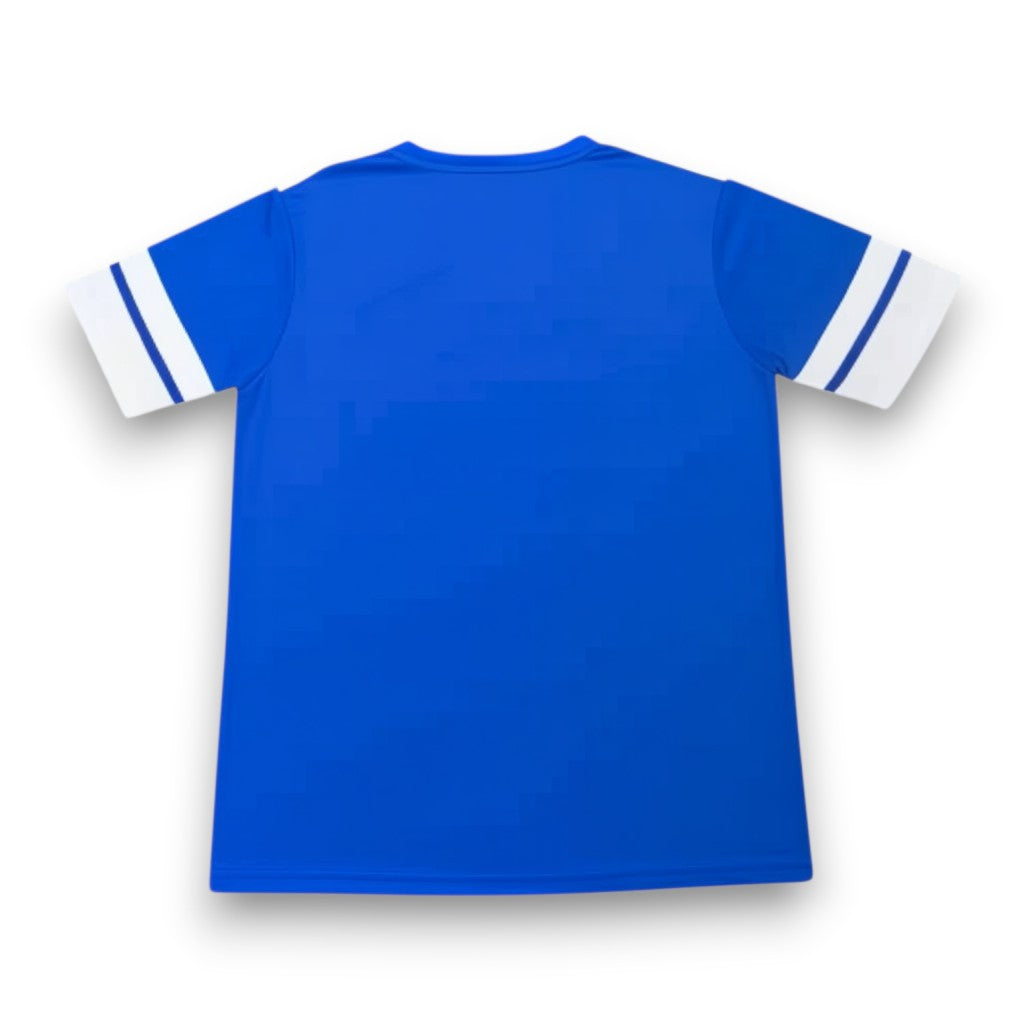 GOATkitz Curaçao 2026 adult home jersey, royal blue with white striped sleeves. Customizable fan version.