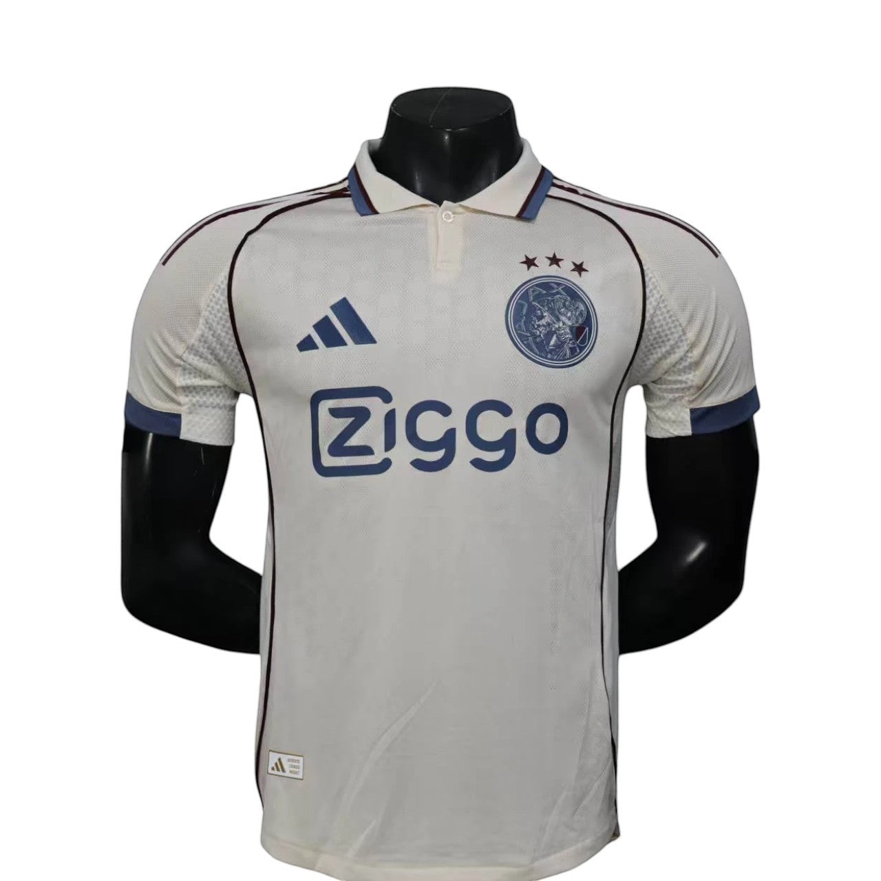 GOATkitz Ajax 2025-26 player version third jersey, off-white with navy trim and Ziggo sponsor. Customizable.
