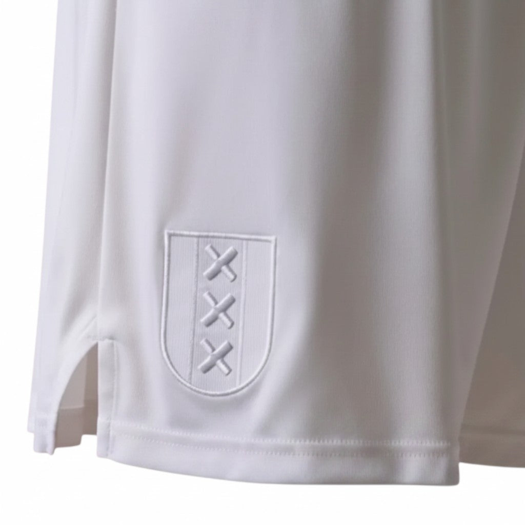 GOATkitz white Ajax 125th Anniversary kids football shorts with embroidered crest and red trim socks.