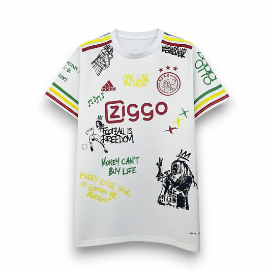 GOATkitz Ajax Special Edition white football jersey with graffiti art, Ziggo logo, and Adidas branding. Features red, yellow, and green striped sleeves.