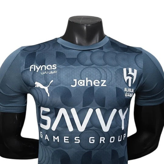 GOATkitz Al-Hilal 2025-26 player version third jersey in dark grey with a geometric circle pattern. Features Puma logo and Al-Hilal crest.