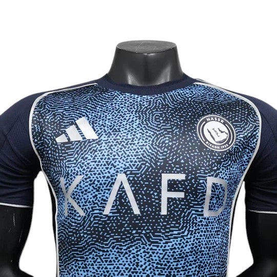 GOATkitz Al-Nassr 2025-26 player version away jersey in navy with a light blue abstract pattern and silver accents.