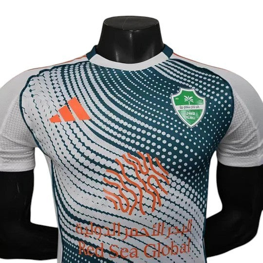 GOATkitz Al-Ahli 2025-26 Player Version Third Jersey in white, green, and orange with a dynamic dot pattern and sponsor logo.