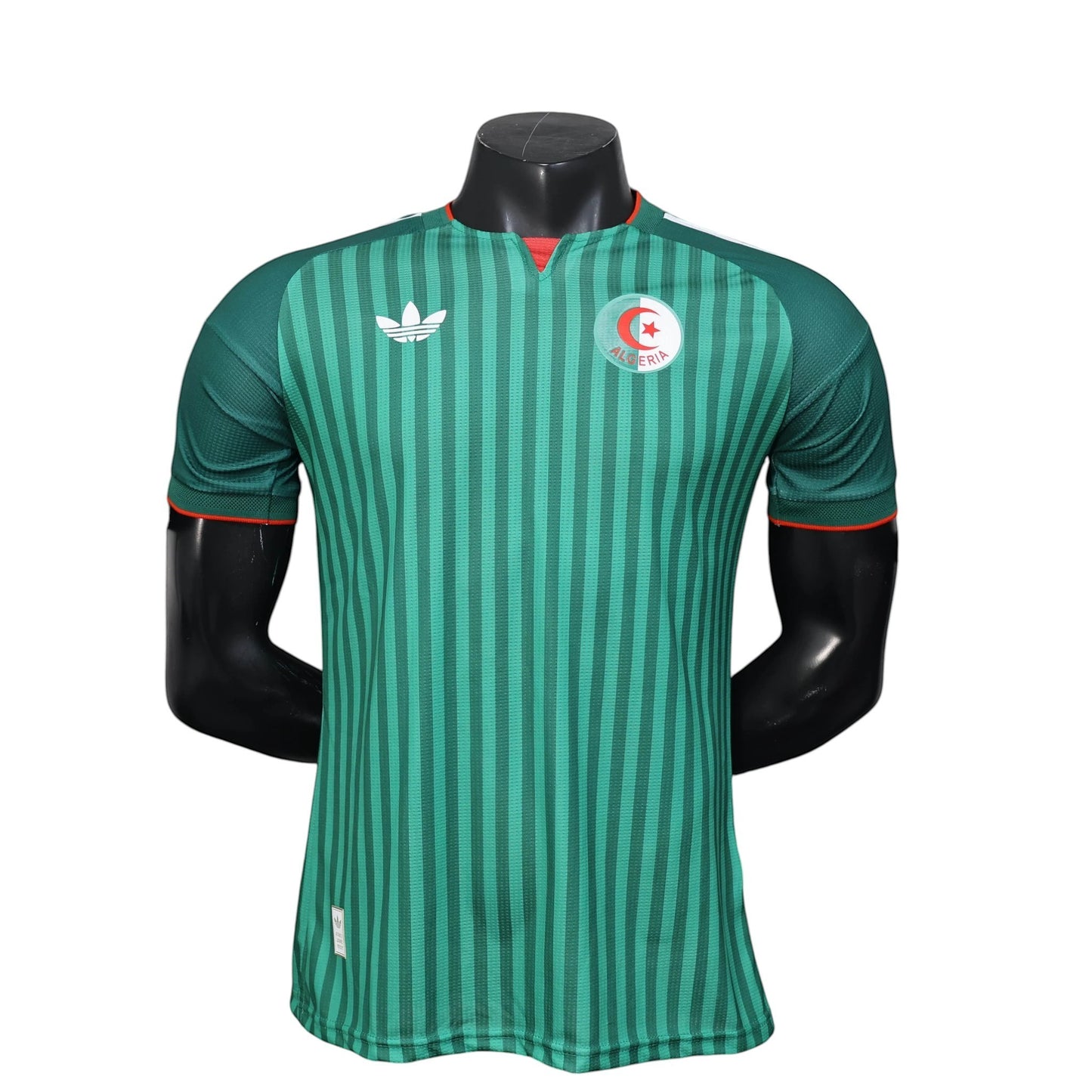 GOATkitz Algeria 2026 player version away jersey in green with vertical stripes and red trim. Features Adidas logo and Algeria crest.