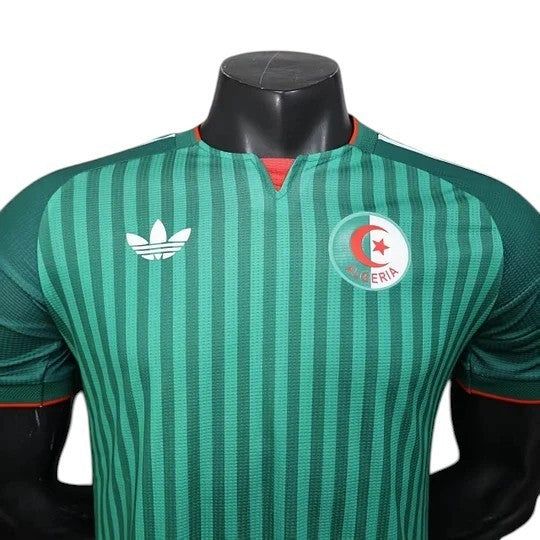 GOATkitz Algeria 2026 player version away jersey in green with vertical stripes and red trim. Features Adidas logo and Algeria crest.