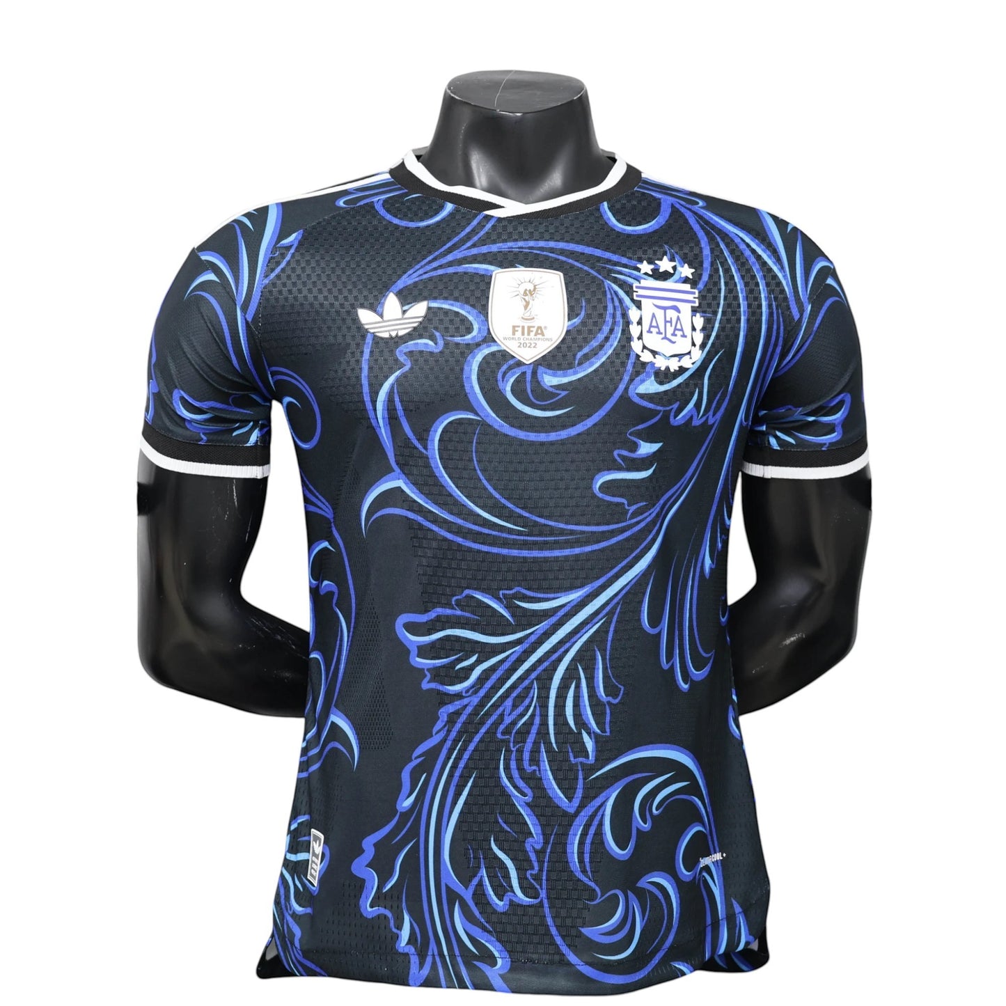 GOATkitz Argentina 2026 player version away jersey, black with blue floral pattern, white trim, FIFA World Cup 2022 badge.