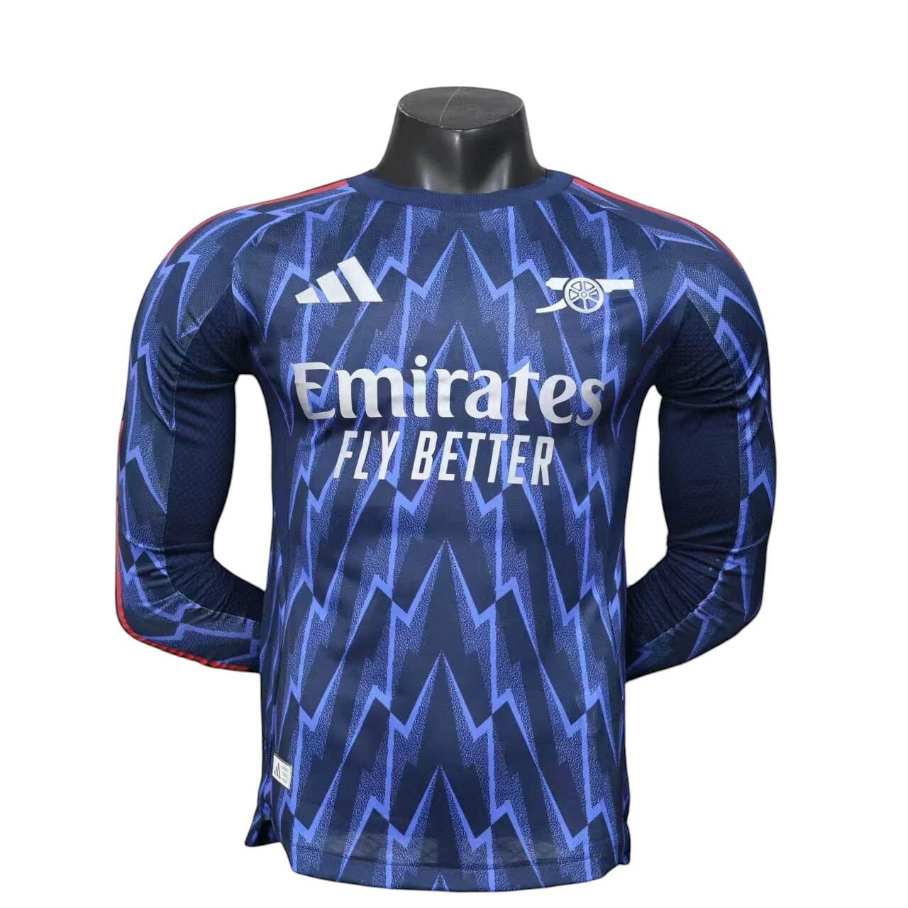 GOATkitz Arsenal 2025-26 adult player version away long sleeve jersey in navy blue with a lightning bolt pattern and red accents.