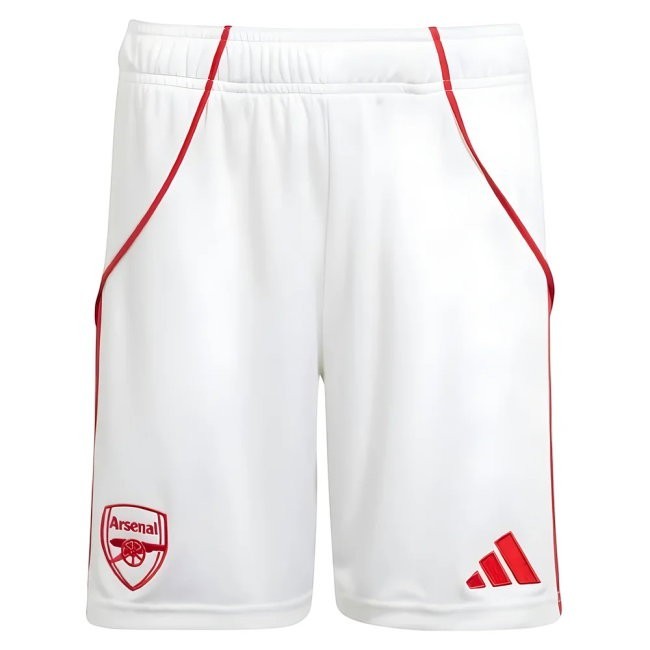 GOATkitz Arsenal 2025-26 kids white football shorts with red trim and embroidered crest. Features elasticated waistband and Adidas logo.