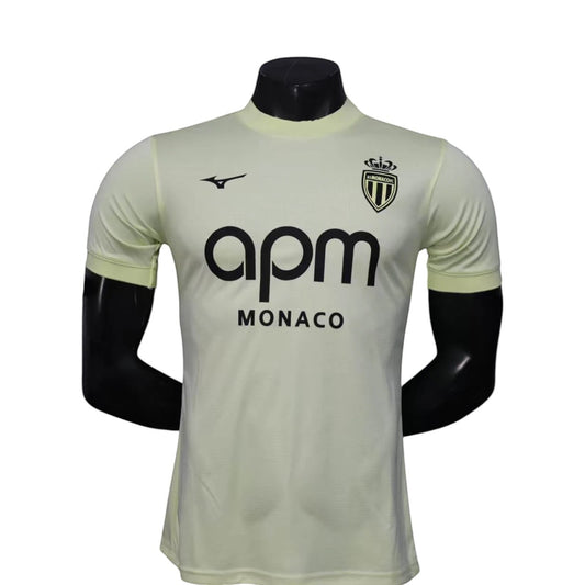 GOATkitz AS Monaco 2025-26 player version third jersey in pale yellow with black APM logo and crest. Short sleeves.
