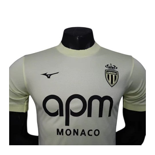 GOATkitz AS Monaco 2025-26 player version third jersey in pale yellow with black APM logo and crest. Short sleeves.