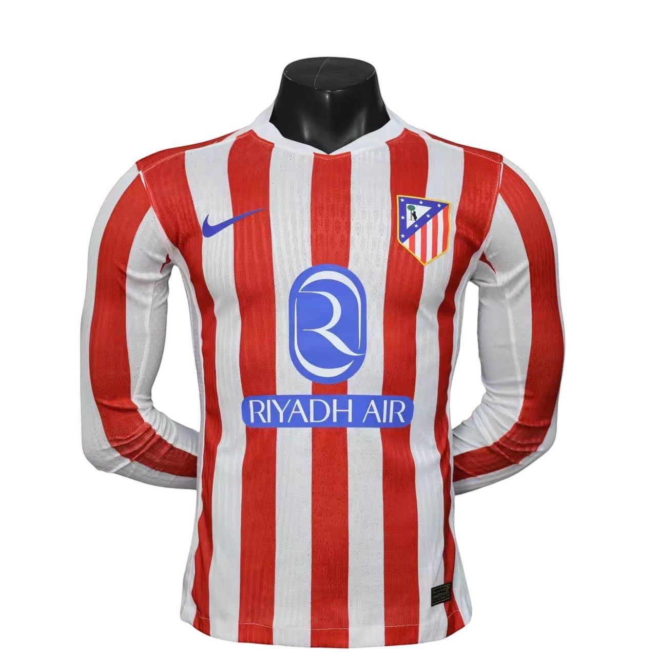 GOATkitz Atlético Madrid 2025-26 red and white striped long sleeve player version jersey with club crest and Riyadh Air sponsor.