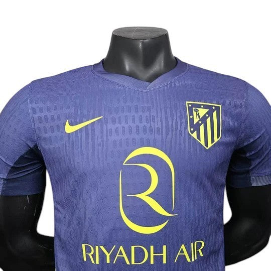 GOATkitz Atlético Madrid 2025-26 player version away jersey in navy blue with yellow accents. Features Nike logo and club crest.