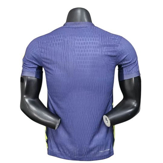 GOATkitz Atlético Madrid 2025-26 adult player version away jersey in navy blue with yellow accents. Features a textured pattern and is customizable.
