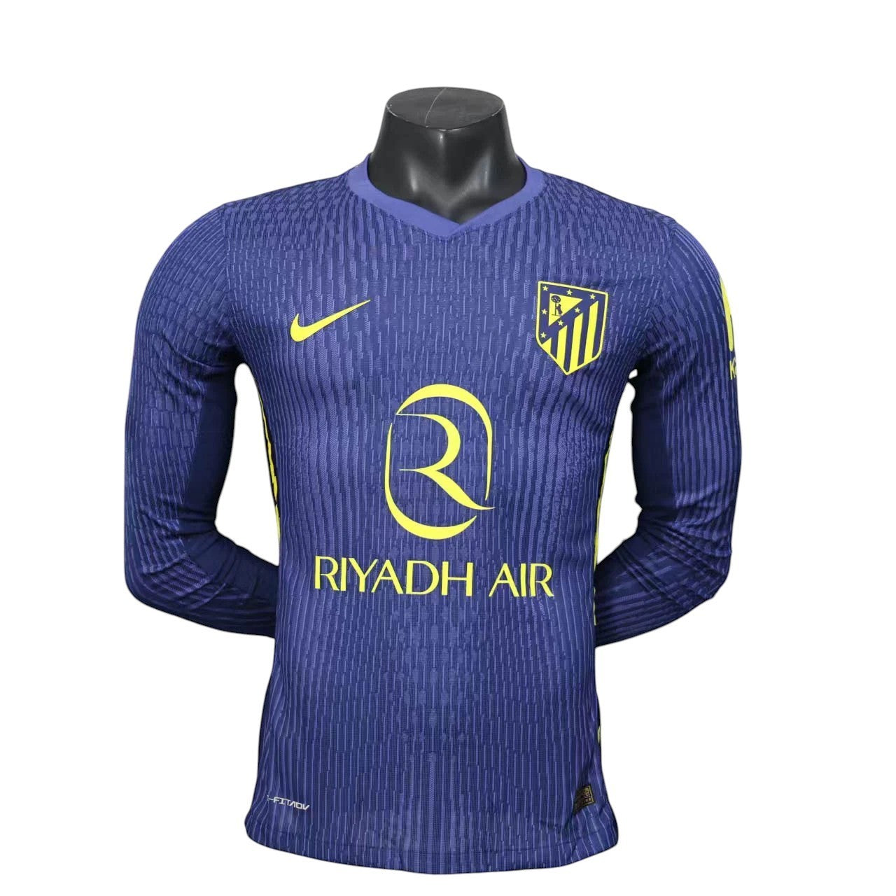 GOATkitz Atlético Madrid 2025-26 adult player version away long sleeve jersey in navy blue with yellow accents and crest.