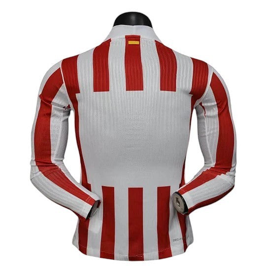 GOATkitz Atlético Madrid 2025-26 long sleeve player version home jersey in white with red vertical stripes. Features Dri-FIT technology.