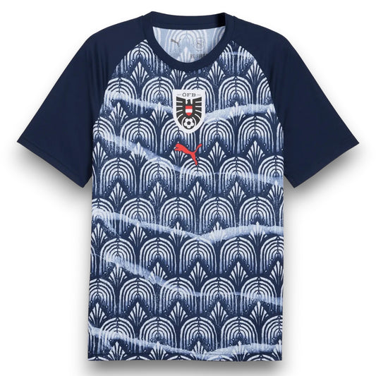 GOATkitz Austria 2026 black training jersey with navy blue sleeves and a repeating white and navy blue art deco pattern. Features the Austrian crest and Puma logo.