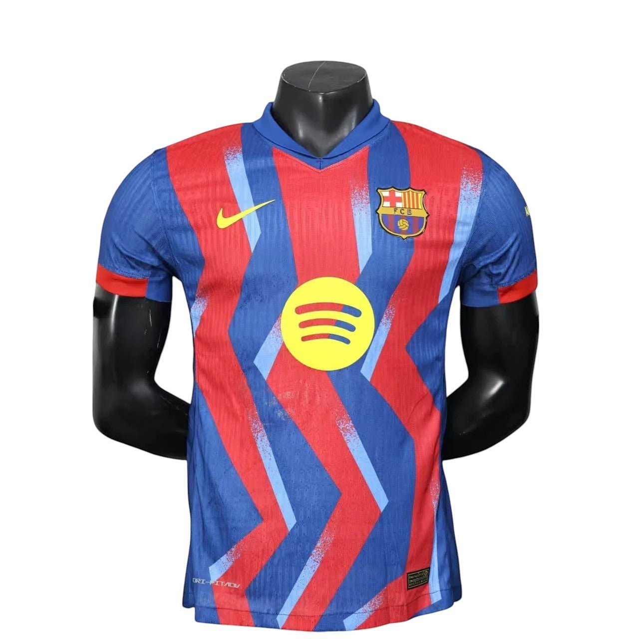 GOATkitz Barcelona 2025-26 adult player version fourth jersey, blue and red with a zigzag pattern and Spotify logo.