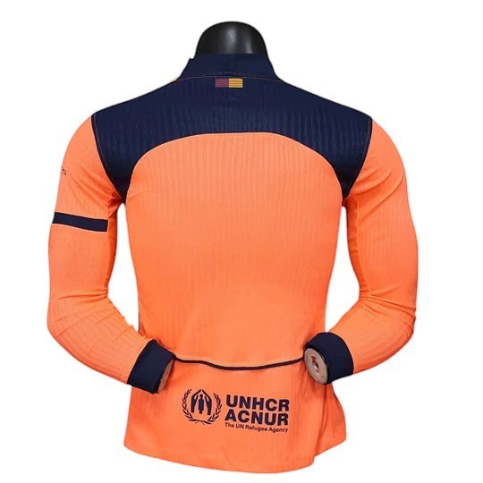 GOATkitz Barcelona 2025-26 adult player version third long sleeve jersey in orange with navy blue accents and UNHCR logo.