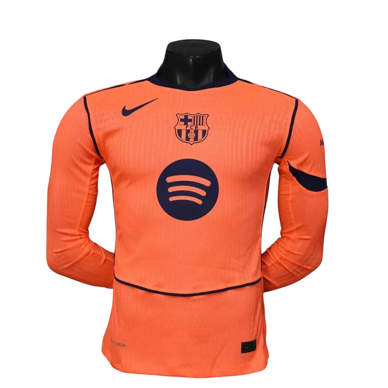 GOATkitz Barcelona 2025-26 orange long sleeve player version jersey with navy accents and logos.
