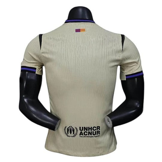 GOATkitz Barcelona 2025-26 away player version jersey in light beige with purple trim and UNHCR logo.