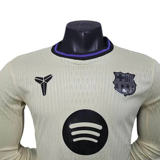 GOATkitz Barcelona 2025-26 away long sleeve player version jersey in light yellow with black and purple trim. Features team crest, Nike logo, and Spotify sponsor.