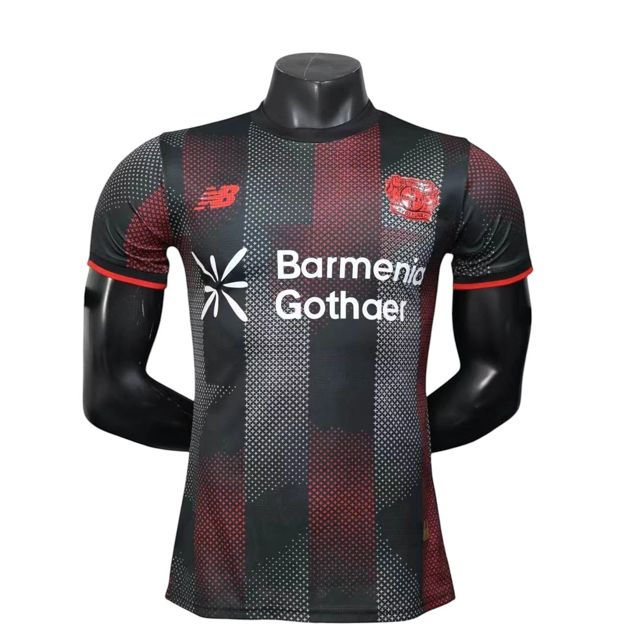 GOATkitz Bayer Leverkusen 2025-26 adult player version home jersey, black with red and white geometric pattern, red trim.