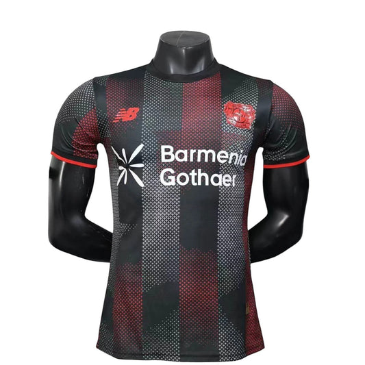 GOATkitz Bayer Leverkusen 2025-26 adult player version home jersey, black with red and white geometric pattern, red trim.