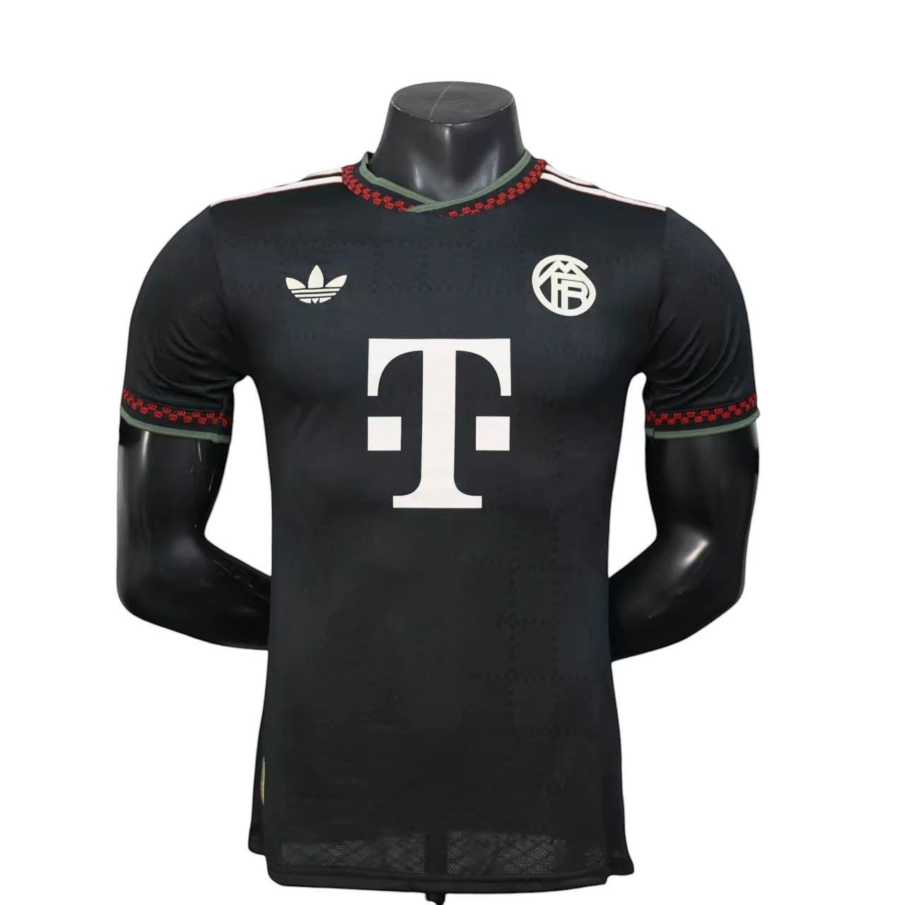 GOATkitz Bayern Munich 2025-26 black player version third jersey with white T-Mobile logo and red/green trim.
