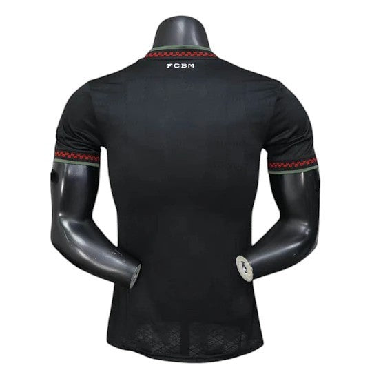 GOATkitz Bayern Munich 2025-26 black player version third jersey with red and green trim on collar and sleeves.