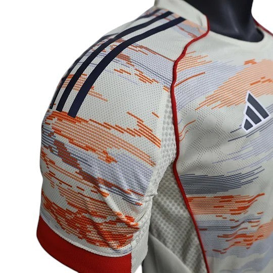 GOATkitz Bayern Munich 2025-26 Player Version Away Jersey, cream with abstract red, blue, and grey pattern. Features Adidas logo.