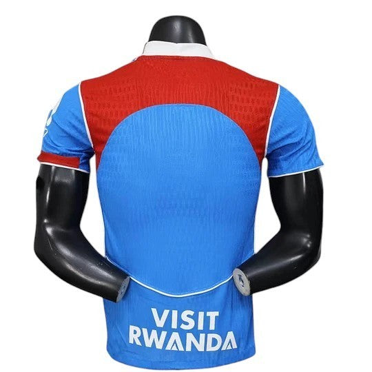 GOATkitz blue and red short-sleeve jersey with white trim and "VISIT RWANDA" text on the back.
