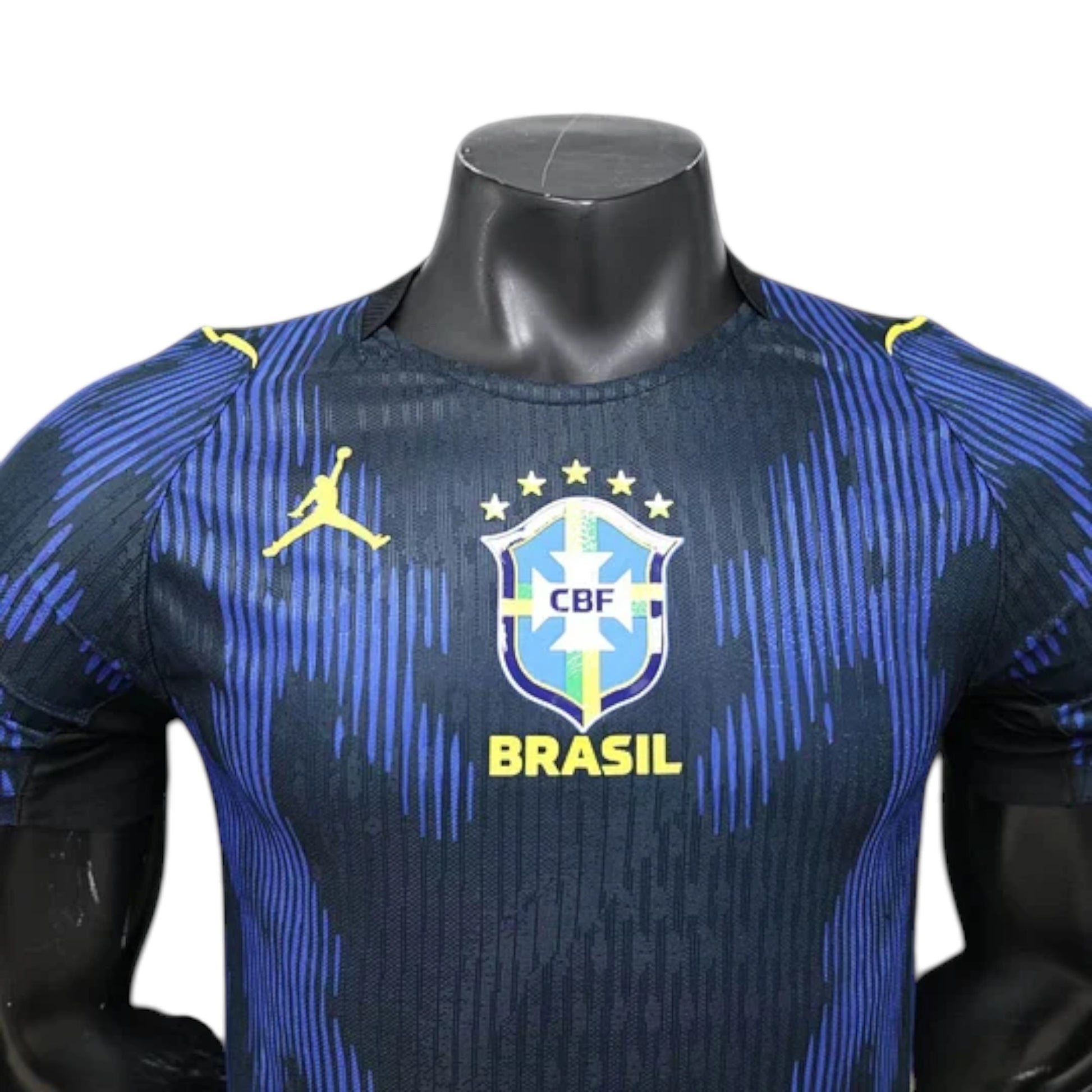 GOATkitz Brazil 2026 player version away jersey in navy blue with blue vertical stripes and yellow accents. Features CBF crest and Jordan logo.