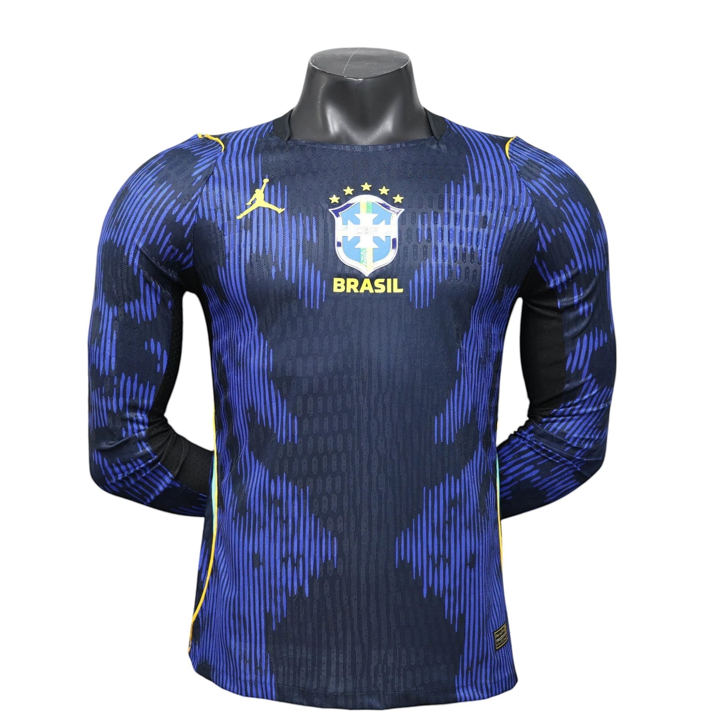 GOATkitz Brazil 2026 long sleeve player version away jersey in navy blue with blue graphic pattern and yellow accents.