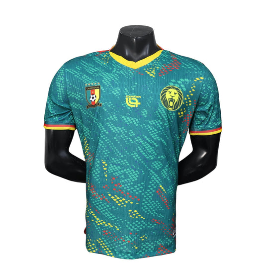 GOATkitz Cameroon 2026 player version home jersey in green with yellow and red accents. Features a lion emblem and customizable badges.