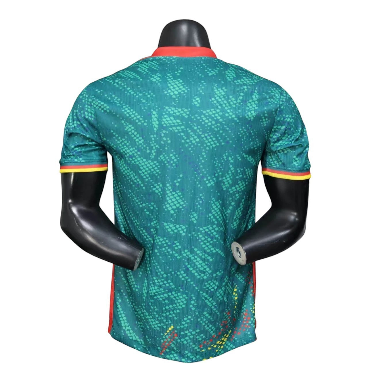 GOATkitz Cameroon 2026 player version home jersey in green with red and yellow trim on the collar and sleeves. Features a customisable name and number.