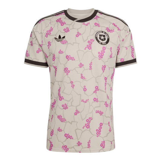 GOATkitz Chile 2026 Adult Away Jersey in light beige with pink floral pattern and dark trim. Features Adidas logo and Chile crest.