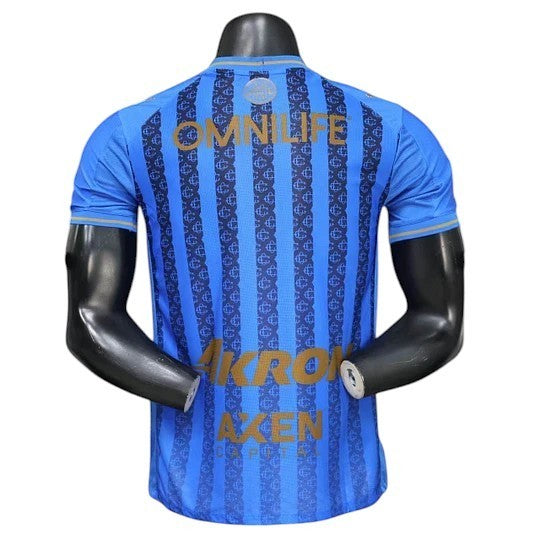 GOATkitz Chivas 2025-26 Player Version Away Jersey, blue with vertical stripes and gold lettering.