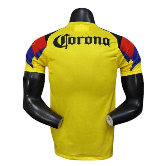 GOATkitz Club América 2025-26 player version home jersey in yellow with black "Corona" text on back. Features red and blue accents on sleeves.