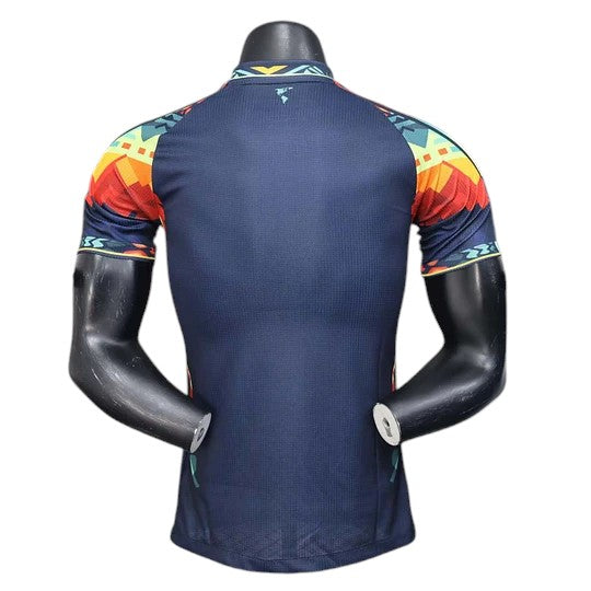GOATkitz Club América 2025-26 dark blue player version jersey with colorful Aztec-inspired sleeve patterns.