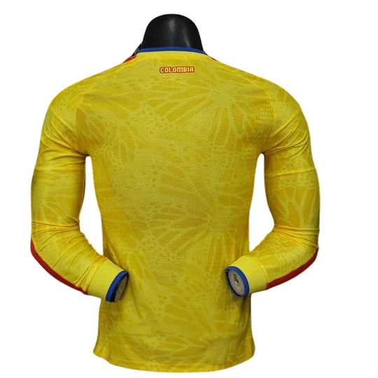 GOATkitz Colombia 2026 long sleeve player version home jersey in yellow with blue and red accents on cuffs. Features a subtle geometric pattern.