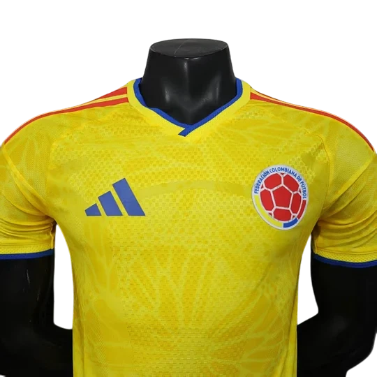 GOATkitz Colombia 2026 player version yellow soccer jersey with blue accents and crest. Features Adidas logo.
