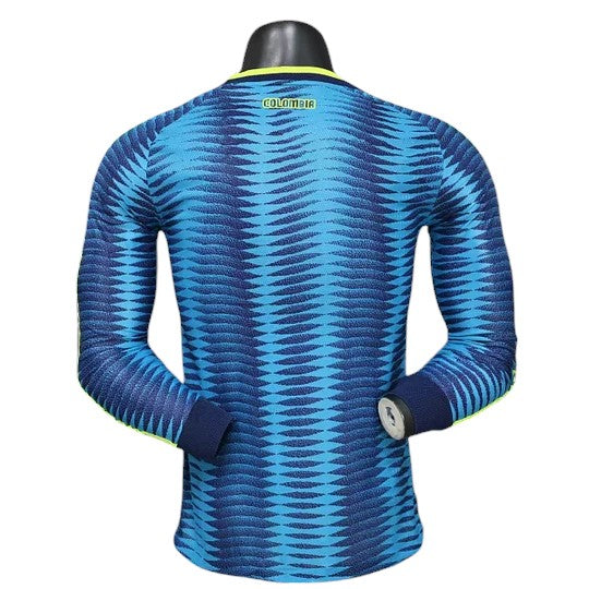 GOATkitz Colombia 2026 long sleeve player version away jersey in blue with a wavy pattern and yellow trim.