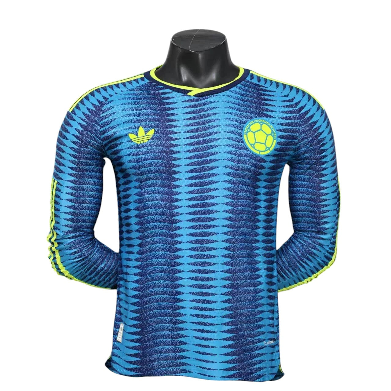 GOATkitz Colombia 2026 long sleeve player version away jersey in blue with yellow accents and a patterned design.