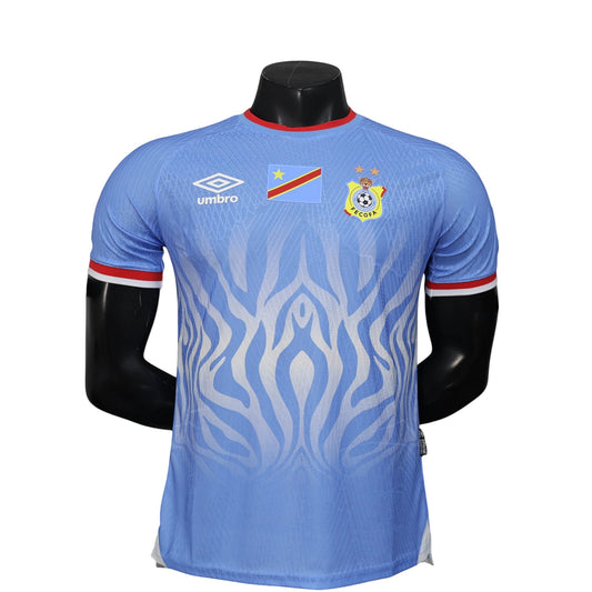 GOATkitz light blue DR Congo 2026 player version football jersey with red trim and white abstract pattern. Features Umbro logo and team crest.