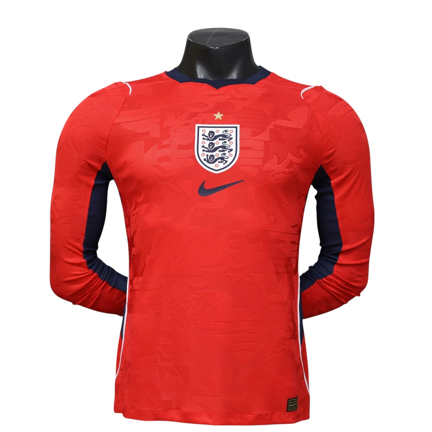 GOATkitz England 2026 player version long sleeve away jersey in red with navy blue accents and England crest.