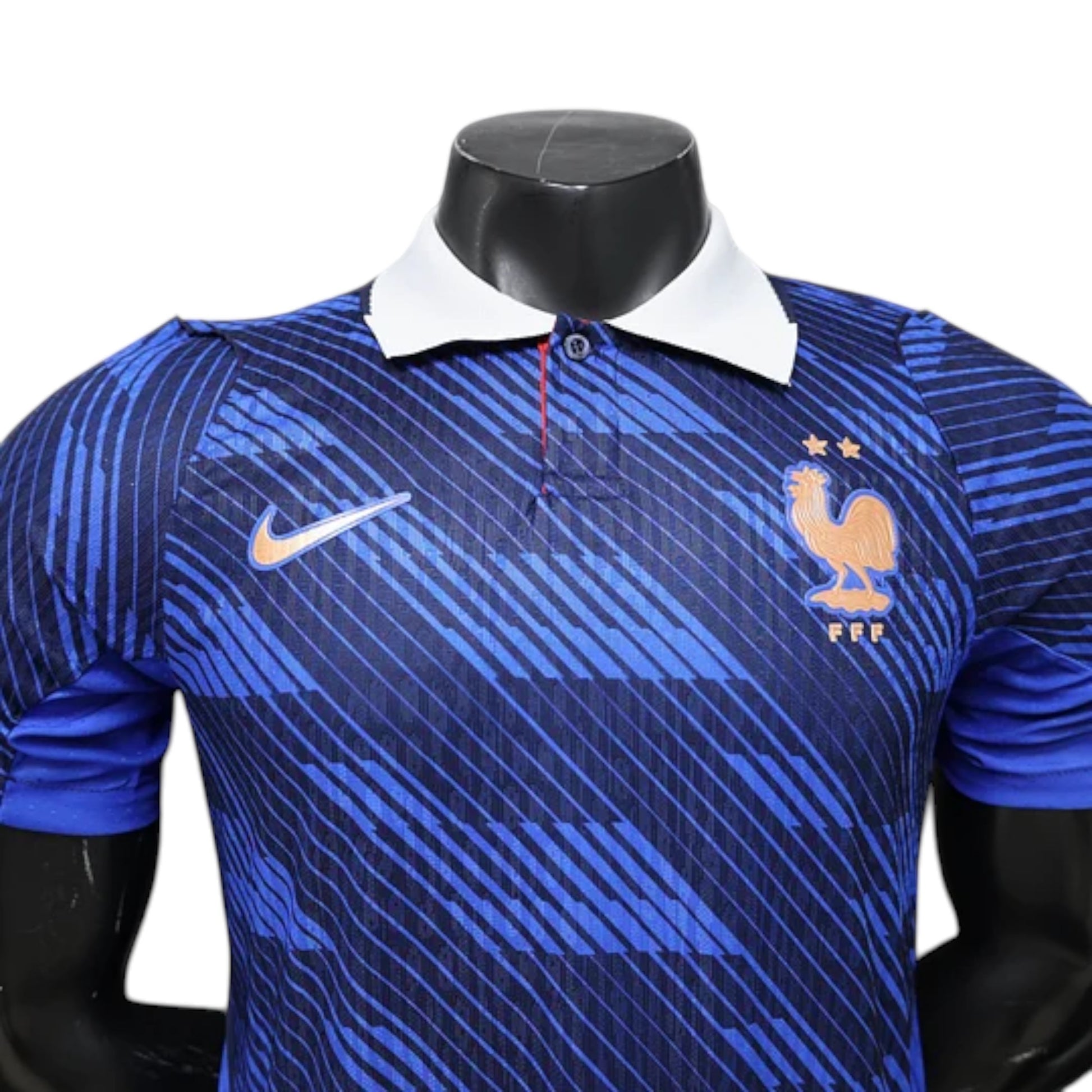 GOATkitz France 2026 player version home jersey in blue with a white collar and orange Nike logo. Features a graphic pattern and the French rooster crest.