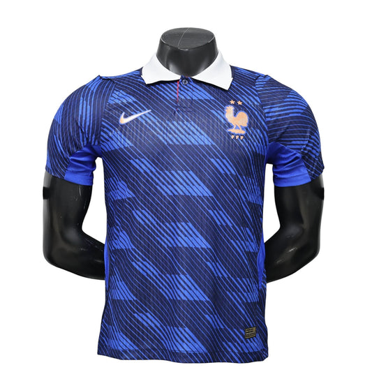 GOATkitz France 2026 player version home jersey in blue with white collar and dynamic stripe pattern. Features Nike logo and FFF crest.